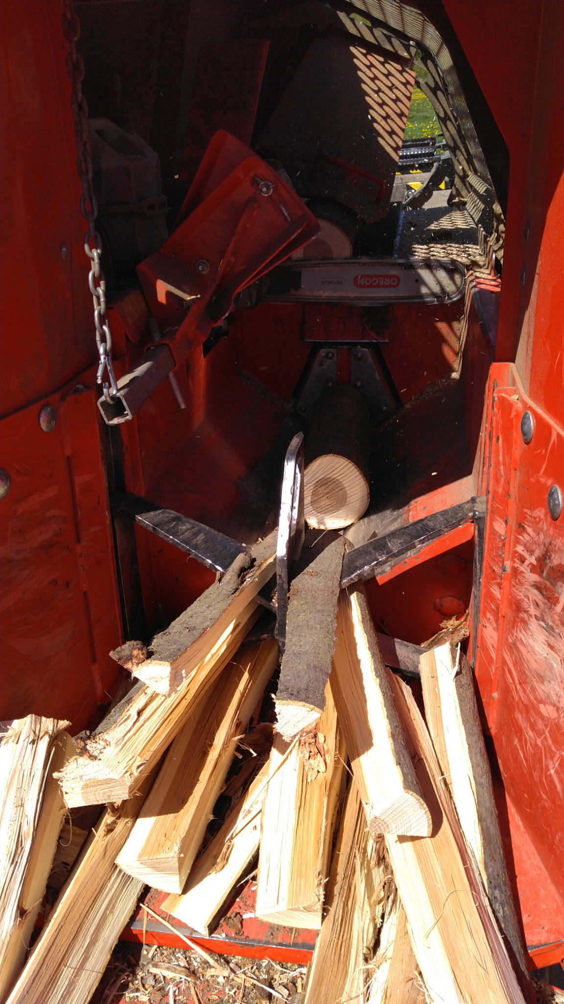 Freshly split firewood loaded into the processor