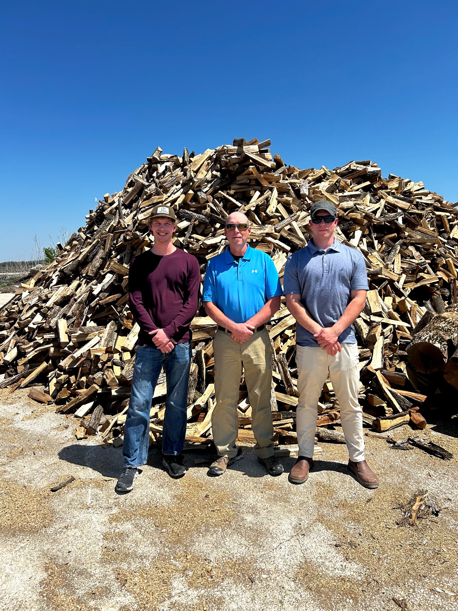 Josh, William, and Colton of Old Fashioned Firewood in front of a fresh load